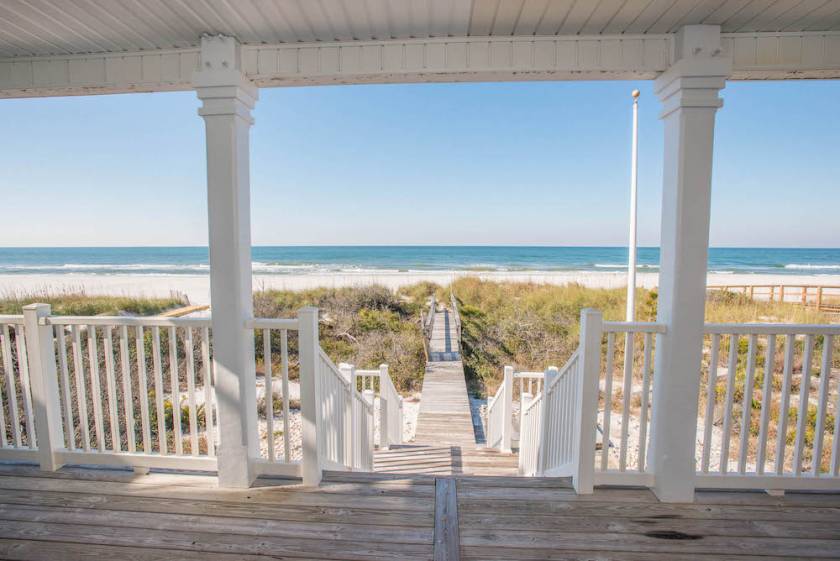 view of beach from a porch of a vacation rental